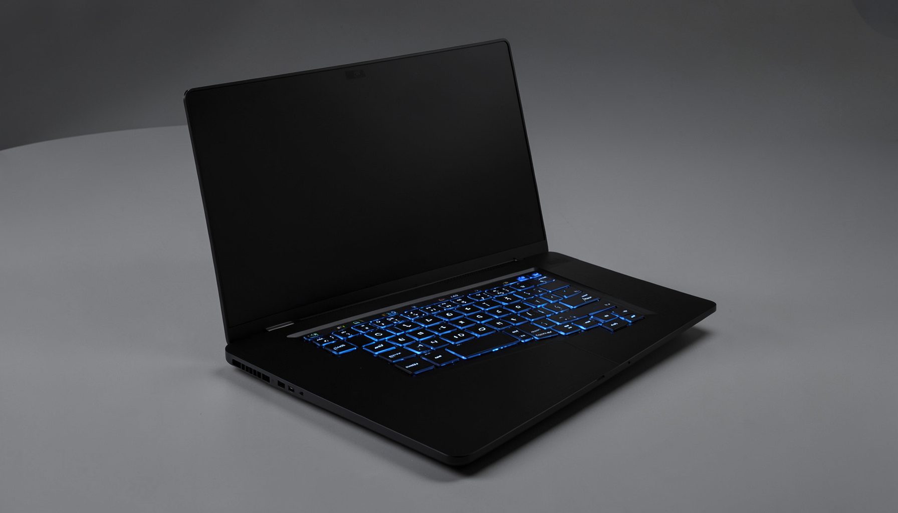 Sleek black laptop with blue-accented keyboard and slim profile, premium gaming aesthetic