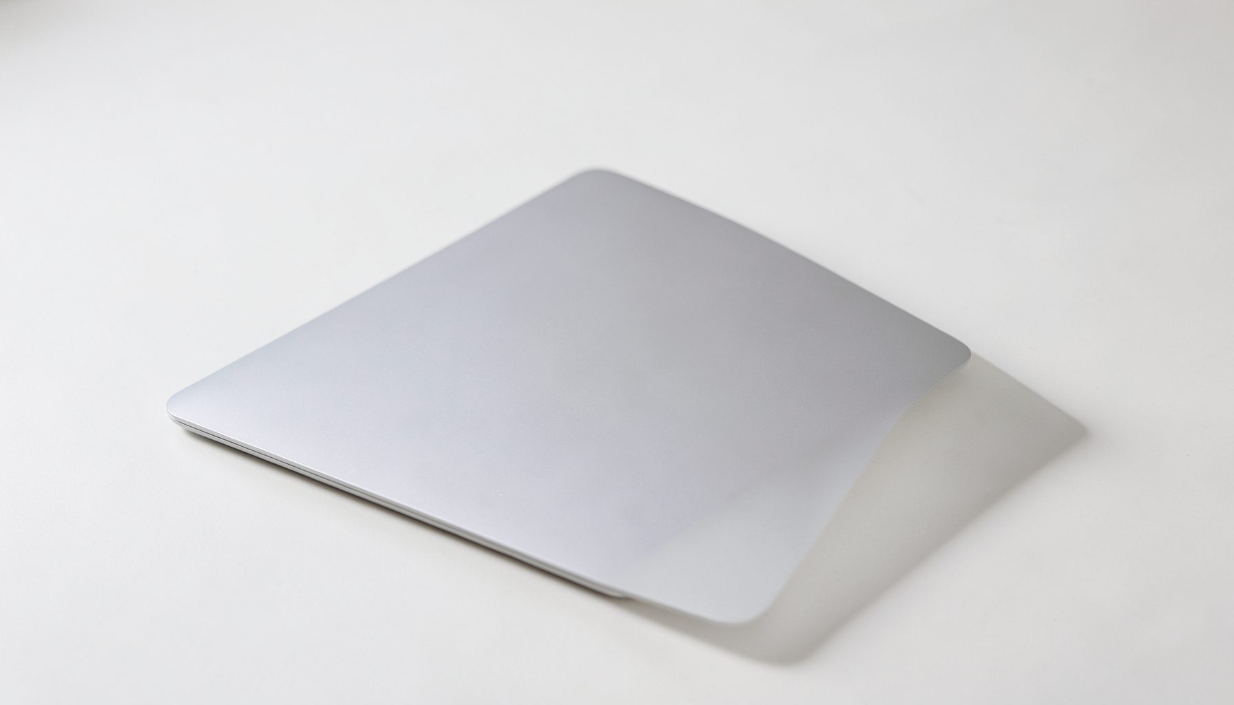 Slim silver laptop with thin bezels on a light surface, clean minimalist look